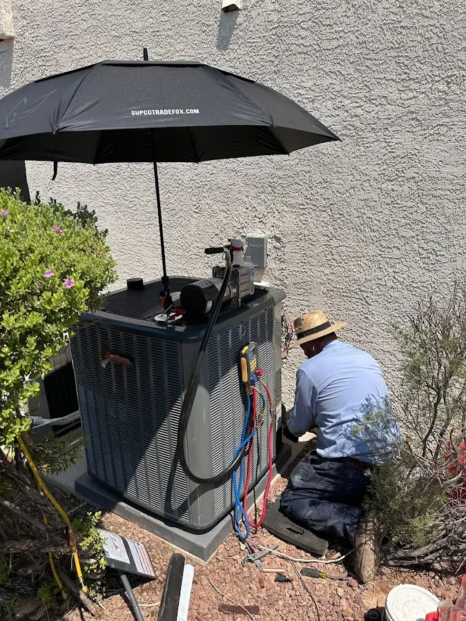 HVAC technician performing outdoor AC maintenance in City of Orange